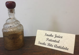 Snake-shaped bottle containing a patented "snake bite antidote."