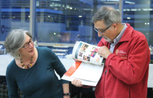 Retired AIHP Assistant Director Elaine Stroud explains her gift to AIHP Executive Director Greg Higby.