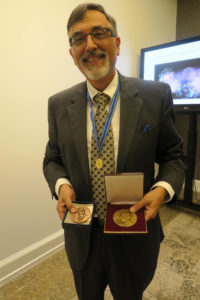 Greg Higby shows the Parmentier Medal (left) and the Urdang Medal he received on Friday at the International Academy Meeting.